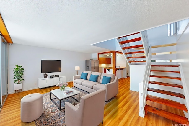 95-312 Kahikinui Ct Unit 213, Mililani, HI 96789 - living area featuring stairway, wood finished floors, and a textured ceiling