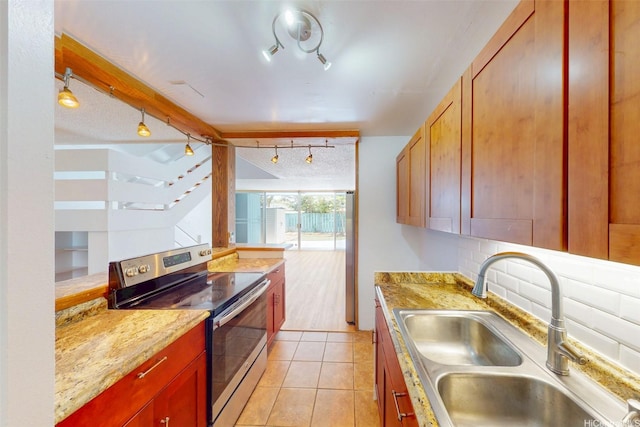 95-312 Kahikinui Ct Unit 213, Mililani, HI 96789 - kitchen with stainless steel electric range oven, track lighting, light tile patterned floors, and light countertops