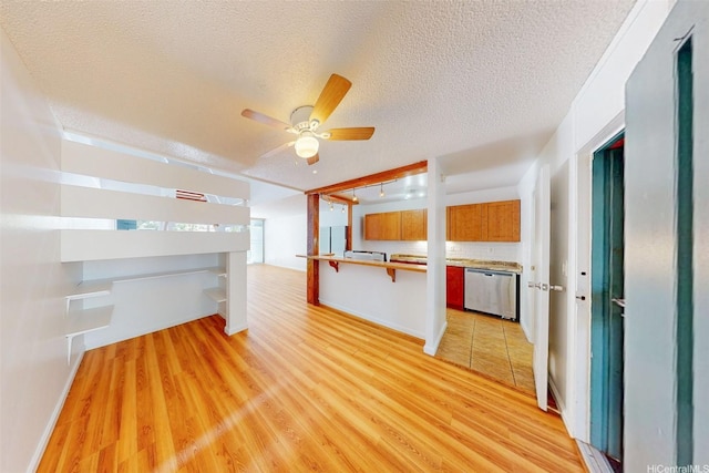 95-312 Kahikinui Ct Unit 213, Mililani, HI 96789 - unfurnished living room with light wood-type flooring, ceiling fan, and a textured ceiling