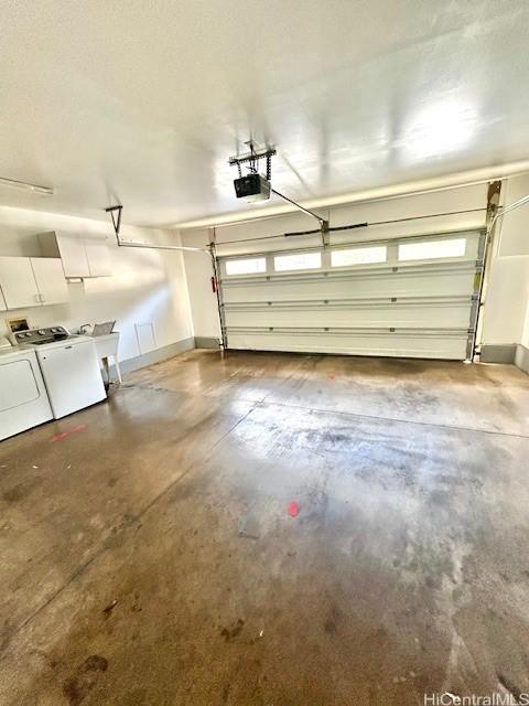 91-280 Makalea St Unit 23, Ewa Beach, HI 96706 - garage featuring washing machine and clothes dryer and a garage door opener