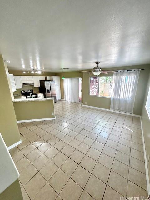 91-280 Makalea St Unit 23, Ewa Beach, HI 96706 - unfurnished living room featuring light tile patterned floors and a ceiling fan