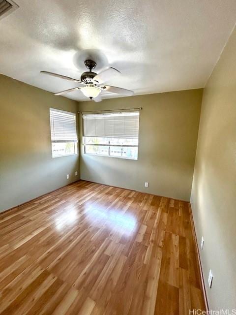 91-280 Makalea St Unit 23, Ewa Beach, HI 96706 - empty room with wood finished floors, ceiling fan, and a textured ceiling