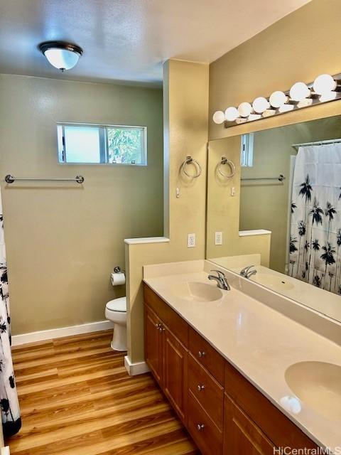 91-280 Makalea St Unit 23, Ewa Beach, HI 96706 - bathroom with wood finished floors, double vanity, and a shower with shower curtain