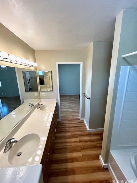 91-280 Makalea St Unit 23, Ewa Beach, HI 96706 - full bathroom with wood finished floors, double vanity, and a bath