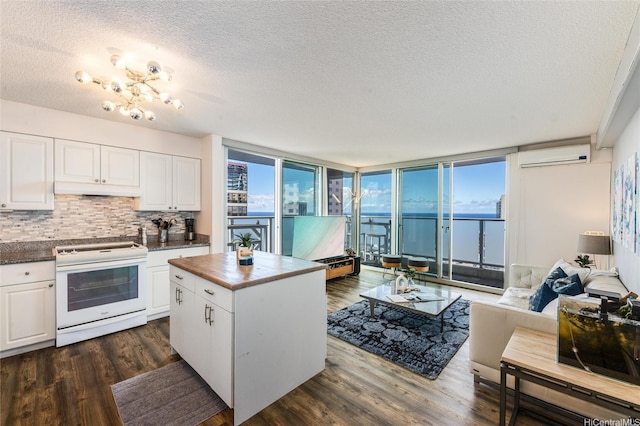 801 S St Unit 3822, Honolulu, HI 96813 - kitchen with electric stove, a wall mounted air conditioner, a textured ceiling, dark wood-type flooring, and white cabinetry