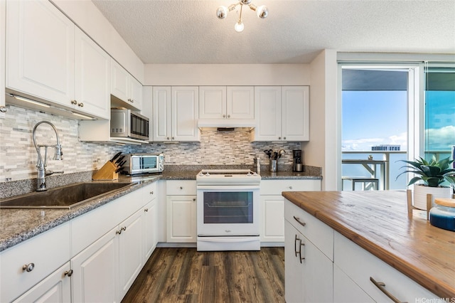 801 S St Unit 3822, Honolulu, HI 96813 - kitchen with white electric range, stainless steel microwave, butcher block counters, a textured ceiling, and dark wood-style flooring