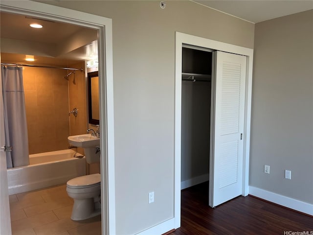 1837 Kalakaua Ave Unit 1103, Honolulu, HI 96815 - bathroom featuring shower / bath combo with shower curtain, a closet, and wood finished floors