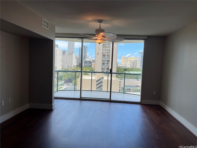 1837 Kalakaua Ave Unit 1103, Honolulu, HI 96815 - unfurnished room with a city view, dark wood-style flooring, ceiling fan, and expansive windows