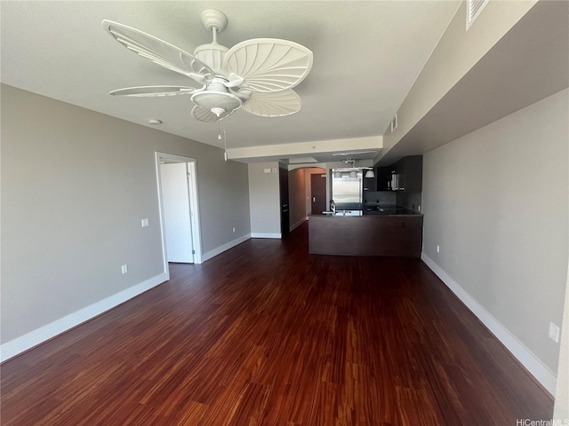 1837 Kalakaua Ave Unit 1103, Honolulu, HI 96815 - unfurnished living room with arched walkways, ceiling fan, and dark wood-style flooring