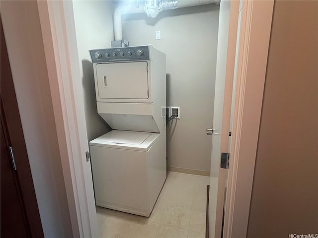 1837 Kalakaua Ave Unit 1103, Honolulu, HI 96815 - washroom with stacked washing machine and dryer and light tile patterned floors