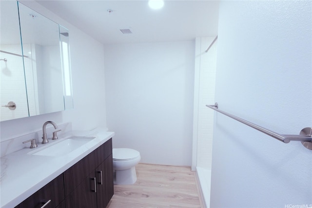 615 Keawe St Unit 3207, Honolulu, HI 96813 - full bathroom with vanity, wood finished floors, and tiled shower
