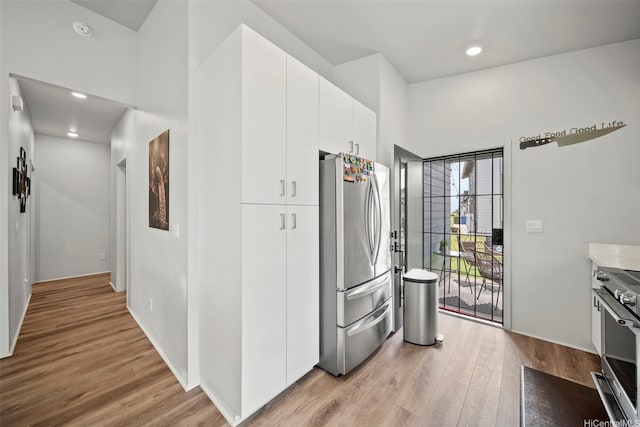 91-1775 Kohanahana Loop, Ewa Beach, HI 96706 - kitchen featuring stainless steel appliances, light wood-type flooring, white cabinets, and recessed lighting