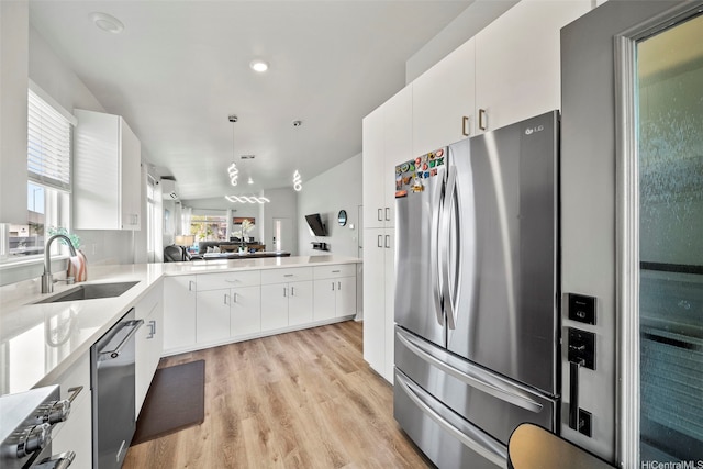 91-1775 Kohanahana Loop, Ewa Beach, HI 96706 - kitchen featuring stainless steel appliances, light wood-style flooring, light countertops, white cabinets, and pendant lighting