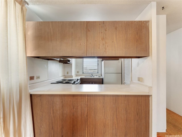 1160 Ala Napunani St Unit 1407, Honolulu, HI 96818 - kitchen with freestanding refrigerator, a peninsula, and light countertops