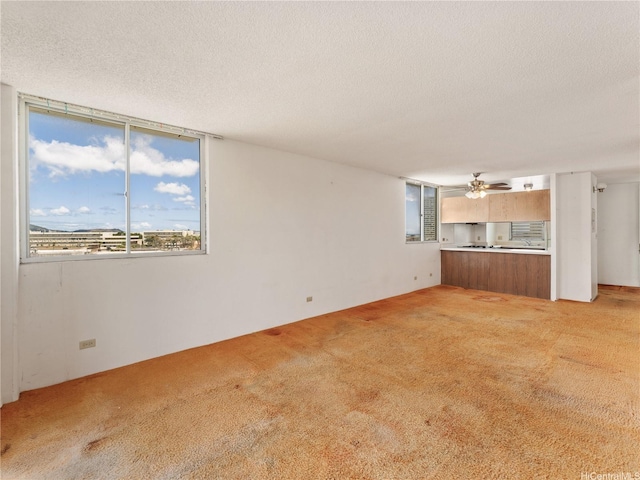 1160 Ala Napunani St Unit 1407, Honolulu, HI 96818 - unfurnished living room with light colored carpet, ceiling fan, and a textured ceiling