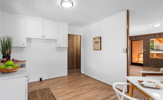 1915 Lohilani St Unit B, Honolulu, HI 96819 - kitchen with light countertops, white cabinetry, light wood-style flooring, and wooden walls