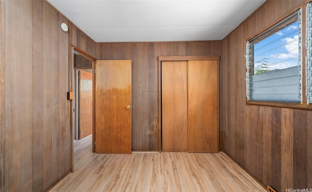 1915 Lohilani St Unit B, Honolulu, HI 96819 - unfurnished bedroom featuring wooden walls, wood finished floors, and a closet