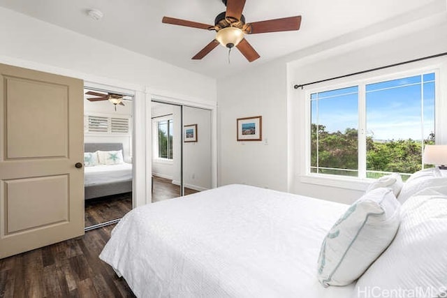 75-6025 Alii Dr Unit L201, Kailua Kona, HI 96740 - bedroom featuring dark wood finished floors, two closets, and a ceiling fan