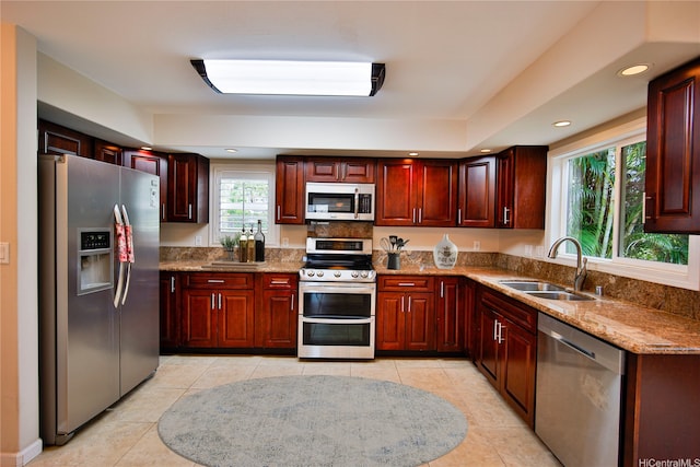 45-521 Halekou Rd Unit B, Kaneohe, HI 96744 - kitchen featuring appliances with stainless steel finishes, dark brown cabinets, light tile patterned floors, light stone countertops, and recessed lighting