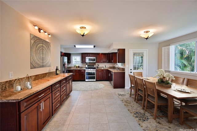 45-521 Halekou Rd Unit B, Kaneohe, HI 96744 - kitchen with appliances with stainless steel finishes, light tile patterned floors, light stone counters, and dark brown cabinets