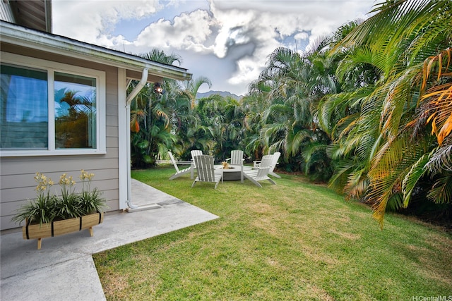 45-521 Halekou Rd Unit B, Kaneohe, HI 96744 - view of green lawn featuring an outdoor fire pit and a patio area