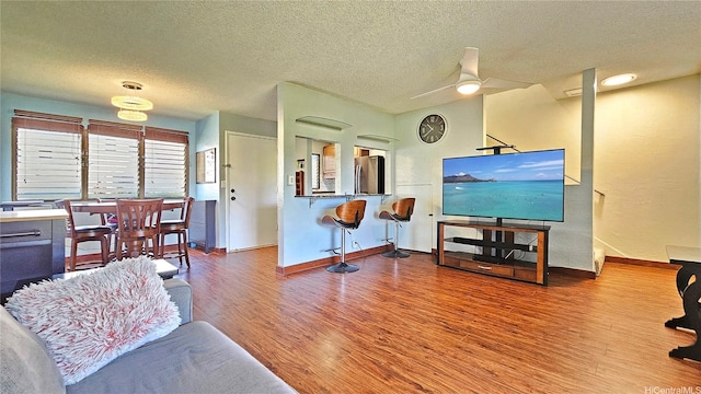 98-441 Kaonohi St Unit 35-3, Aiea, HI 96701 - living room with wood finished floors, a textured ceiling, and a ceiling fan
