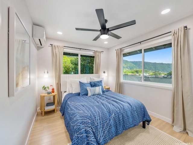 3641 Kumuone St, Honolulu, HI 96822 - bedroom with a wall mounted AC, light wood-style flooring, ceiling fan, and recessed lighting