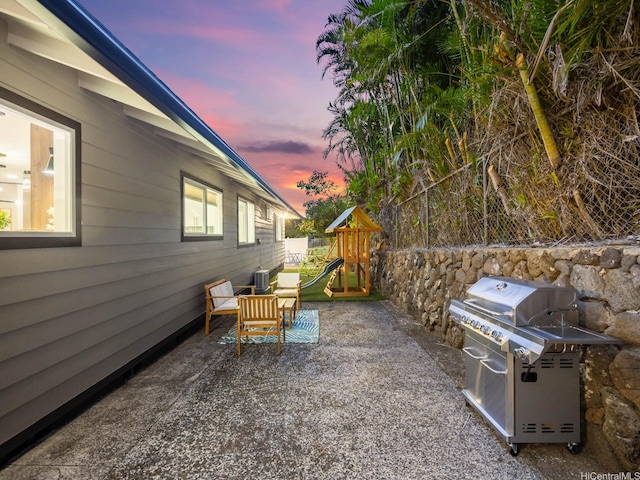 3641 Kumuone St, Honolulu, HI 96822 - patio terrace at dusk featuring grilling area, a playground, and a patio