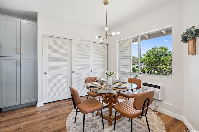 91-985 Puahala St Unit 42R, Ewa Beach, HI 96706 - dining space with a chandelier, light wood-style flooring, and a wall mounted air conditioner