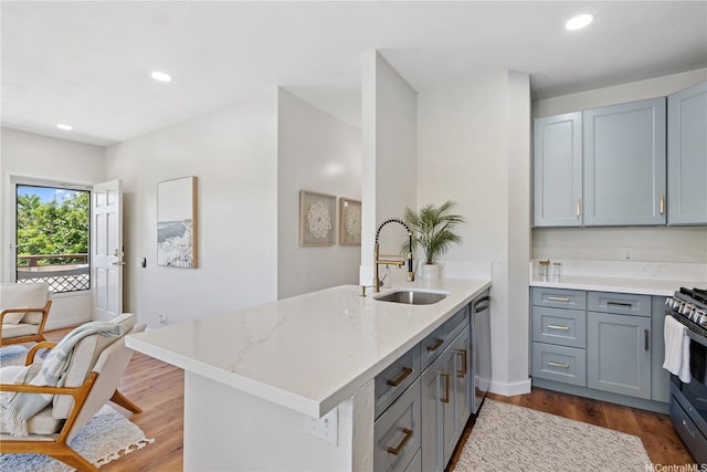 91-985 Puahala St Unit 42R, Ewa Beach, HI 96706 - kitchen with a peninsula, gray cabinets, stainless steel appliances, light stone counters, and wood finished floors