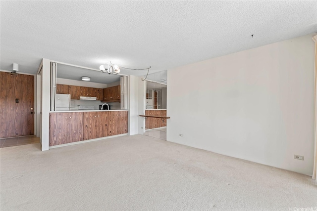 1717 Mott Smith Dr Unit 2212, Honolulu, HI 96822 - unfurnished living room with light colored carpet, a textured ceiling, and a chandelier
