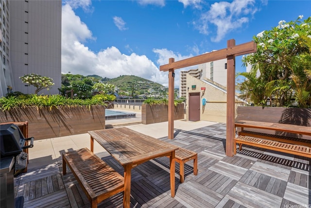 1717 Mott Smith Dr Unit 2212, Honolulu, HI 96822 - wooden deck with a mountain view, grilling area, a pool, and a patio area