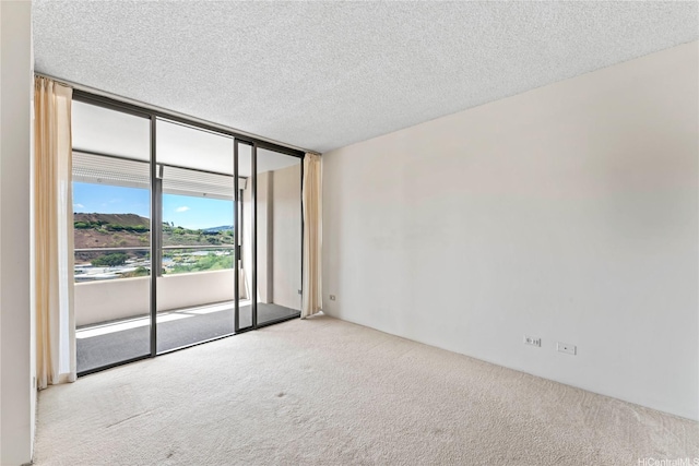 1717 Mott Smith Dr Unit 2212, Honolulu, HI 96822 - carpeted empty room featuring a textured ceiling and expansive windows