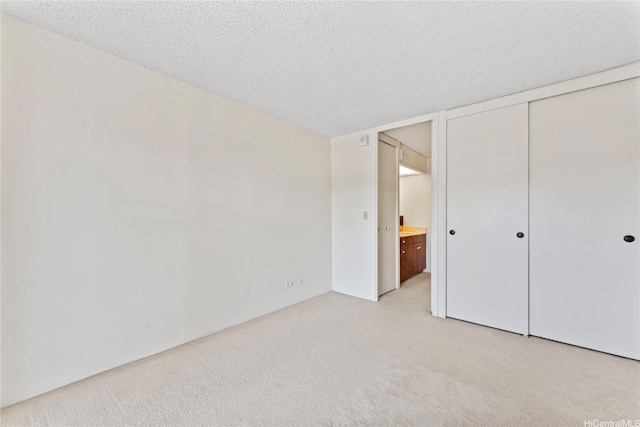 1717 Mott Smith Dr Unit 2212, Honolulu, HI 96822 - unfurnished bedroom featuring light colored carpet, a textured ceiling, and a closet