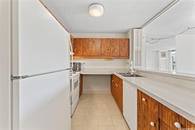1717 Mott Smith Dr Unit 2212, Honolulu, HI 96822 - kitchen with white appliances, brown cabinets, light countertops, a textured ceiling, and light tile patterned flooring