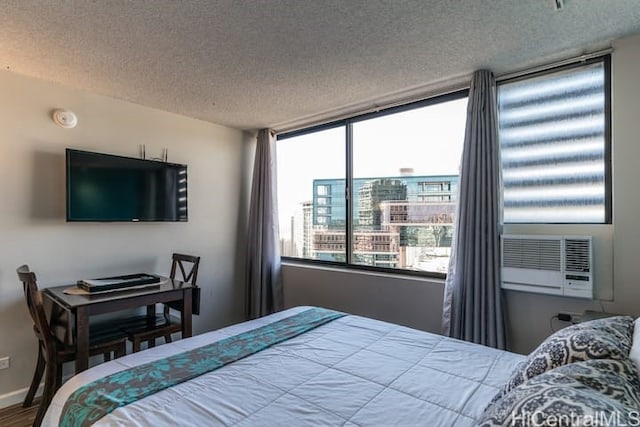 444 Niu St Unit 3608, Honolulu, HI 96815 - bedroom with a textured ceiling, multiple windows, wood finished floors, and cooling unit