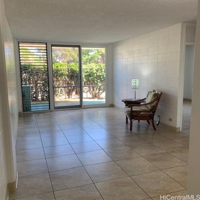 3410 Leahi Ave Unit 107, Honolulu, HI 96815 - tiled spare room with a textured ceiling and healthy amount of natural light