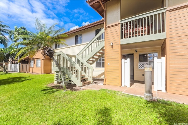 91-1093 Namahoe St Unit 5E, Kapolei, HI 96707 - rear view of property featuring stairway, a lawn, and stucco siding