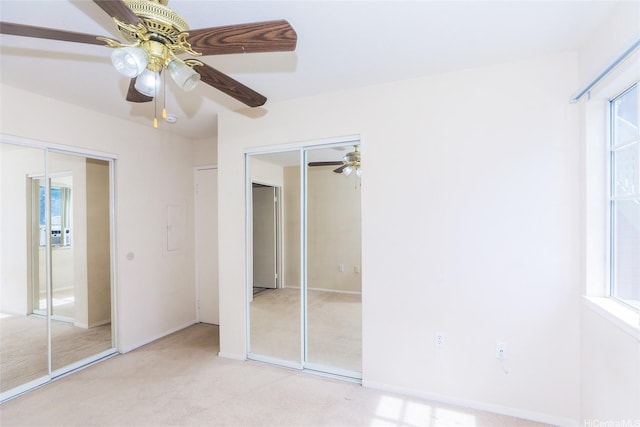 91-1093 Namahoe St Unit 5E, Kapolei, HI 96707 - unfurnished bedroom with light colored carpet, a ceiling fan, and multiple windows
