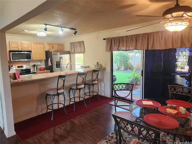 94-373 Leleaka St, Mililani, HI 96789 - kitchen with appliances with stainless steel finishes, a textured ceiling, dark wood-type flooring, track lighting, and a peninsula