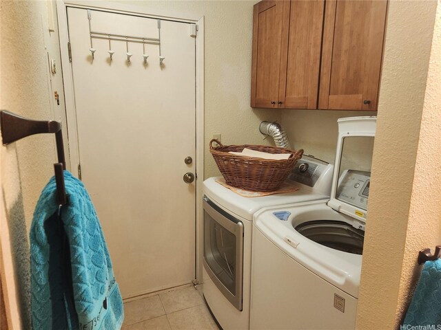94-373 Leleaka St, Mililani, HI 96789 - laundry room featuring separate washer and dryer, cabinet space, and light tile patterned floors