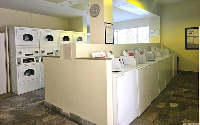 445 Seaside Ave Unit 2608, Honolulu, HI 96815 - community laundry featuring washer and dryer, stacked washer and clothes dryer, and dark stone finish flooring