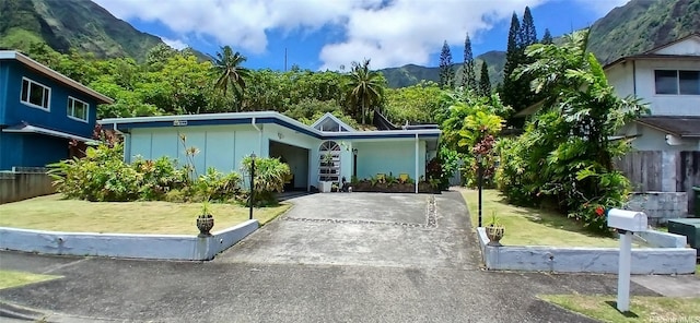 46-046 Puulau Pl, Kaneohe, HI 96744 - view of front of house with concrete driveway, a mountain view, a garage, and board and batten siding