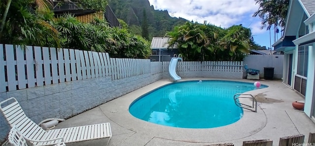 46-046 Puulau Pl, Kaneohe, HI 96744 - view of pool featuring a water slide, a fenced backyard, and a patio