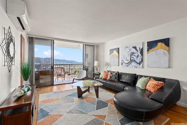 990 Ala Nanala St Unit 35B, Honolulu, HI 96818 - living area with a wall mounted AC, wood finished floors, and floor to ceiling windows