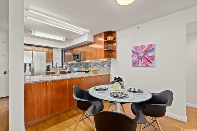 990 Ala Nanala St Unit 35B, Honolulu, HI 96818 - kitchen with stainless steel appliances, brown cabinets, decorative backsplash, light wood-style floors, and open shelves