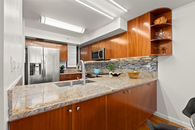 990 Ala Nanala St Unit 35B, Honolulu, HI 96818 - kitchen with stainless steel appliances, brown cabinetry, backsplash, and light stone countertops