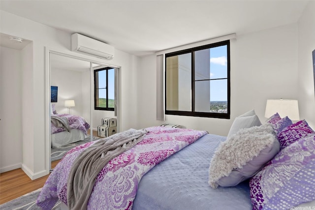 990 Ala Nanala St Unit 35B, Honolulu, HI 96818 - bedroom with a wall unit AC and wood finished floors