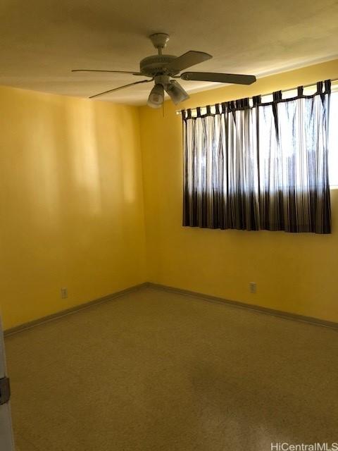94010 Leolua St Unit 215, Waipahu, HI 96797 - unfurnished room with ceiling fan and baseboards
