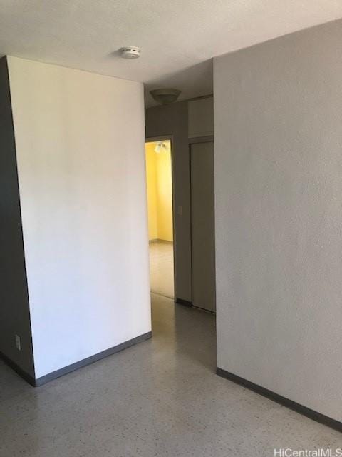 94010 Leolua St Unit 215, Waipahu, HI 96797 - unfurnished room with a smoke detector and dark speckled floor